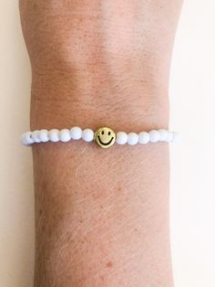 "customize your very own happy smiley face stretchy bracelet, made to order in your size! you will receive one white beaded bracelet with your choice of center smiley bead (gold or yellow). PLEASE NOTE: you will receive ONE bracelet with this order. these super trendy and versatile stretch bracelets are the perfect little accessory for your wrist. they are dainty and beautiful by themselves, but also look great when combined and stacked. you can add to your stack right here: http://www.etsy.com/ White Hypoallergenic Friendship Bracelets For Everyday, White Stretch Bracelet With Smiley Face For Gift, White Bracelets With Smiley Face For Gift, Casual White Friendship Bracelets With Smiley Face, Everyday White Bracelets With Smiley Face, White Smiley Face Bracelet As Gift, Playful White Friendship Bracelets With Smiley Face, Casual White Smiley Face Friendship Bracelets, White Playful Smiley Face Friendship Bracelets