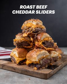 a pile of cheeseburger sliders on a cutting board with the text roast beef cheddar sliders