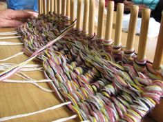 the weaving is being worked on by two people