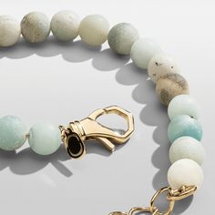 Hand-strung with a blend of ocean-coloured beads, this statement bracelet is one-of-a-kind. Made exclusively from real stone, each bead has a unique matte finish and natural veining, ensuring no two pieces are alike. Its 18 karat gold accents make it perfect for wearing solo or pairing with your favourite gold pieces, while its adjustable-length lobster clasp guarantees a perfect fit around the wrist. One Size: Adjustable (18-22cm) Peace of Mind: Lifetime Warranty Included Ice Necklace, Real Stone, Pearl Gemstone, Statement Bracelet, Cord Bracelets, Earrings Collection, Gemstone Bracelets, Stone Bracelet, Chain Pendants