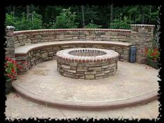 an outdoor fire pit surrounded by stone walls