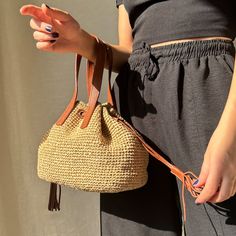 This elegant Raffia Crochet Bucket Bag is specially designed to add a touch of sophistication to your summer outfits. Handcrafted from 100% natural raffia, this bag stands out for its durability and unique design. Known as a Natural Drawstring Bag, it features leather straps that make it suitable for both wrist and hand carry. This Handmade Chic Purse is the perfect accessory for beach outings or special events like weddings. As a luxury accessory, this bag is both functional and stylish. Its sp Luxury Straw Tote Bag For Evening, Luxury Chic Crochet Bucket Bag, Luxury Chic Crochet Shopping Bag, Luxury Bucket Bag Pouch As Gift, Luxury Chic Pouch Straw Bag, Luxury Designer Bucket Bag For The Beach, Luxury Summer Bucket Bag For Beach, Crochet Drawstring Bucket Bag, Luxury Chic Bucket Beach Bag