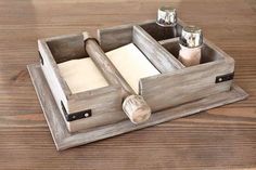 a wooden tray with two compartments holding napkins and salt and pepper shakers