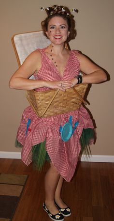 a woman in a red and white dress holding a basket with blue decorations on it