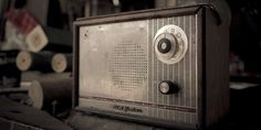 an old radio sitting on top of a wooden table