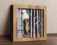 a wooden frame with a deer in the woods