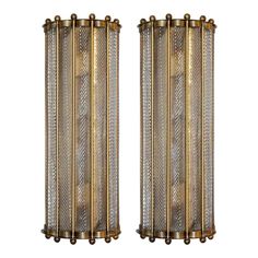 pair of brass sconces with glass panels and metal rods, circa 20th century