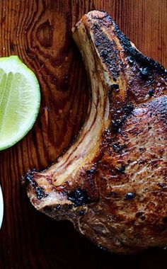 a steak with limes on the side next to it