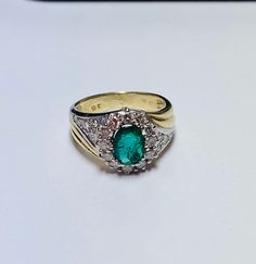 Beautiful Vintage 14k Yellow Gold Natural Oval Shape Emerald Ring 100% Natural Emeralds Emerald(s) 1.00CT Diamond: 0.80CT Color: G Clarity: SI1 Total ring weight: 5.2GR Ring sizing available free of charge For more information regarding this item feel free to reach me so I can accommodate your needs. Thank you Oval Cabochon Signet Ring In Fine Jewelry Style, Oval Green Signet Ring For Anniversary, Green Oval Signet Ring For Anniversary, Timeless Yellow Gold Cluster Ring With Oval Shape, Exquisite Oval Yellow Gold Cluster Ring, Oval Emerald Ring Stamped 14k, Oval Emerald Ring Stamped 14k Gold, Timeless Oval Emerald Ring Hallmarked, Timeless Oval Hallmarked Emerald Ring