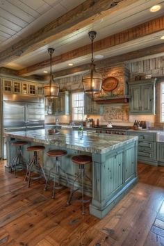 a large kitchen with wooden floors and green cabinets