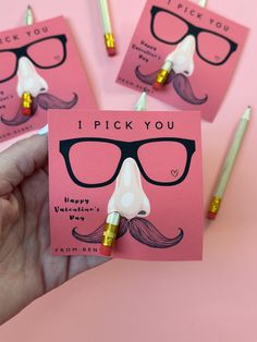 a hand holding a pink card with glasses on it and the words i pick you