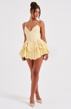 Wear this pretty playsuit on repeat, cut from our premium chiffon which is super floaty and lightweight. Featuring a layered ruffle skirt with built in shorts, this plunge neck design is backless with adjustable straps for your perfect fit. Partner with barely there heeled sandals and a bright bag. 



Colour: Lemon.

Premium non-stretch chiffon.

Fully lined.

Layered ruffle skirt with built in shorts.

Plunge neckline.

Adjustable straps.

Internal tie at waist.

Backless design.

Invisible zi Backless Chiffon Mini Dress With Ruffles, Party Mini Dress With Ruffled Chiffon Skirt, Flirty V-neck Ruffle Dress For Summer, Summer Ruffle Mini Dress For Night Out, Chic Chiffon Mini Dress With Ruffled Skirt, Summer Chiffon Ruffle Dress For Date Night, Elegant Tiered Mini Dress For Summer, Summer Ruffled Backless Dress, Summer Backless Dress With Ruffled Skirt