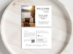 a white plate topped with a wooden table and a card that says welcome to the lake