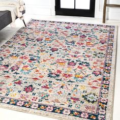 an area rug with colorful flowers on it