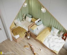 an aerial view of two beds in a room with green walls and wood flooring