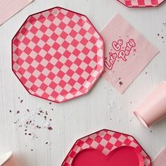 pink and white checkered paper plates with hearts on them, along with other items