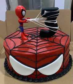 a spiderman cake is on display in a box