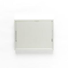 a white square mirror hanging on the wall