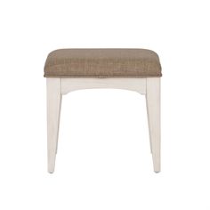 a white wooden stool with a brown seat cushion on it's back and sides