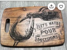 a wooden cutting board with a drawing of a wine glass and the words let's make four decision on it