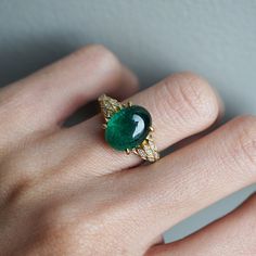 Read about our payment plans before proceeding.This is what dreams are made of. This emerald ring features an insanely gorgeous deep green natural cabochon emerald stone, embellished with 57 natural white diamonds with details like phoenix wings. A classy and sleek ring to treasure forever. Handcrafted in your choice of 14K yellow gold, rose gold, and white gold. The emerald shown is the exact same emerald you will receive. 14K solid gold Natural 12*9mm natural cabochon emerald. Approx. 2.8ct~. Cabochon Ring Design, Elegant Emerald Cabochon Ring, Luxury Elegant Emerald Ring Oval Cabochon, Fine Jewelry Emerald Oval Cabochon Ring, Luxury 14k Gold Oval Cabochon Emerald Ring, Emerald Design, Necklace Set Indian Bridal Jewelry, Phoenix Wings, Emerald Ring Design