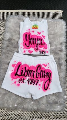 two white shorts with pink ink on them and the words juicy lita gang written in black