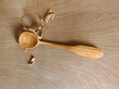 a wooden spoon and some pieces of wood on a table