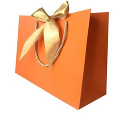 an orange shopping bag with a gold bow