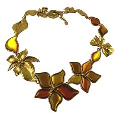 JEAN LOUIS SCHERRER gorgeous vintage gold toned necklace featuring textured bows, leaves and flowers embellished with orange/yellow resin cabochons. Panther head spring clasp. Adjustable length. Marked SCHERRER Paris Made in France. Indicative measurements : adjustable length from approx. 52.5 cm (20.67 inches) to approx. 57 cm (22.44 inches) / largest flower approx. max. 7 cm x max. 7 cm (2.76 inches x 2.76 inches). NOTES - This is a preloved vintage item, therefore it might have imperfections. Gold Metal Flower Necklace For Party, Necklaces Flower, Jean Louis Scherrer, Panther Head, Yellow Resin, Gold Scarf, Cluster Necklace, Station Necklace, Floral Necklace