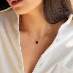 Statement meets simplicity with our beaded Waverly Charm Necklace featuring a dainty black enamel square pendant on a satellite chain and adjustable lobster claw clasp closure. Pair with jeans or your favorite skirt and you have a go-to outfit piece. Material: High Quality Solid 925 Sterling Silver Finish: Sterling Silver ∙ 18K Gold Featuring an ~8mm Black Enamel Square Pendant, with a satellite chain - adjustable length 16 inches to 18 inches SKU: RR-NR106 Rectangular Charm Necklaces For Everyday, Everyday Charm Necklaces With Delicate Chain And Square Pendant, Everyday Charm Necklaces With Square Pendant And Delicate Chain, Everyday Charm Necklace With Square Pendant And Adjustable Chain, Everyday Charm Necklace With Square Pendant, Black Pendant Charm Necklace, Black Pendant Charm Necklace For Everyday, Everyday Black Pendant Charm Necklace, Delicate Chain Charm Necklace With Square Pendant