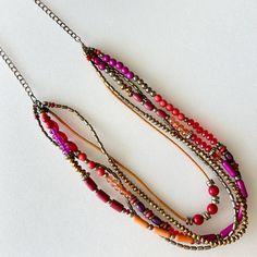 This sweet bintage necklace has five layers. The beads have different shapes and colors. 26" long Thank you for visiting my shop! LOVE, LUCK AND BLESSINGS🌹 Orange And Purple Jewerly Beads, Red Multi-strand Beaded Necklace With Spacer Beads, Red Multi-strand Beaded Chain Jewelry, Red Multi-strand Beaded Chain Necklaces, Red Multi-strand Beaded Chain Necklace, Multi-strand Red Necklace With Colorful Beads, Colorful Beads Multi-strand Layered Necklace Gift, Red Multi-strand Bohemian Necklace, Colorful Beads Multi-strand Necklace As Gift