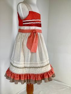 This  Moana inspired dress is made of cottons with lace trims.  It has a double ruffle at hem and the bodice is lined in broadcloth .   There is a back zipper and all seams are finished. This is a smoke free and pet free environment. SIZE    WAIST    LENGTH   3T ---   22" ----  22"  4T ---   23" ----  23"  5 ----   24"  ----  24.5"  6 ---- 24.5" ----  25.5" Fitted Cotton Ruffle Dress With Ruffled Straps, Cotton Dresses With Ruffle Hem And Ruffled Straps, Fitted Sleeveless Cotton Ruffle Dress, Sleeveless Fitted Cotton Ruffle Dress, Cotton Dress With Ruffle Hem And Ruffled Straps, Cotton Dress With Ruffled Hem And Straps, Cotton Dress With Ruffled Straps And Lining, Sleeveless Cotton Dress With Lace Trim, Fitted Ruffle Sundress For Dress-up