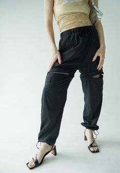 It doesn't get more functional than the Double Take Utility Pant. One minute they're the chicest, most comfortable activewear pant of your dreams, and the next they're your favorite high waisted active shorts. The pants feature two cargo pockets, hidden zippers for a seamless transition into shorts, and adjustable ankles to make it as easy as possible to slip the bottom half off over your sneakers. Running from afternoon workout to a fun happy hour with friends? Ditch the sneakers, cinch the adj Outdoor Relaxed Fit Cargo Pants With Built-in Shorts, Casual Compressive Bottoms With Hip Pockets, Sporty High Waist Pants With Built-in Shorts, Versatile Stretch Bottoms For Streetwear, Outdoor Compressive 2-in-1 Bottoms, Versatile High Waist Parachute Pants With Relaxed Fit, Stretch Parachute Pants With Cargo Pockets In Techwear Style, Athleisure Bottoms With Cargo Pockets And Relaxed Fit, Relaxed Fit Athleisure Bottoms With Cargo Pockets