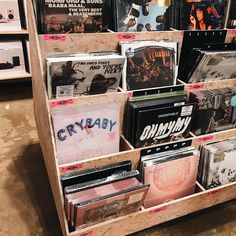 a wooden shelf filled with lots of records