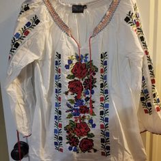 Never Worn Peasant Blouse With Floral Embroidery On Front And On Sleeves As Well As Around Collar Peasant Style Tunic Top With Floral Embroidery, Folk Style Embroidered Tunic Top For Spring, Folk Style Peasant Top With Embroidered Sleeves For Festival, Bohemian Spring Tops With Embroidered Border, Bohemian Tops With Embroidered Border For Spring, Peasant Style Tunic For Spring, Spring Peasant Top With Multicolor Intricate Embroidery, Folk Style Floral Embroidered Peasant Top For Spring, Folk Style Peasant Top With Floral Embroidery For Spring