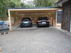 two cars parked in a carport next to each other on a brick driveway area