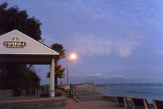 the steps leading to the beach are lit up by street lamps and lanterns at dusk