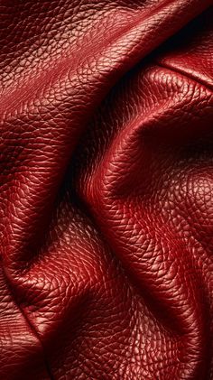 red leather textured up close to the camera, as it is being used for an image