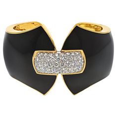 From David Webb's iconic Manhattan Minimalism collection, this exquisite black enamel and diamond cuff bracelet is a true work of art. Expertly crafted in 18 karat yellow gold and platinum, this bracelet features 53 round brilliant cut diamonds weighing approximately 3.51 carats total. These diamonds are of the highest quality, with F-G color and VS clarity, ensuring maximum brilliance and sparkle. The black enamel finish adds a touch of sophistication and elegance to the piece, while the cuff's Diamond Cuff Bracelet, David Webb, Diamond Birthstone, Metal Bracelets, Round Brilliant Cut Diamond, Black Enamel, Brilliant Cut Diamond, Estate Jewelry, Round Brilliant