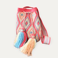 a colorful bag with two tassels on the bottom and one tassel hanging from it