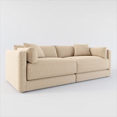 a large beige couch with pillows on it's back and arms, in front of a white background