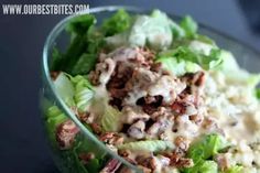 a salad in a glass bowl with dressing on top