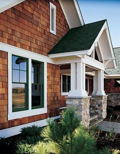 a house with brown shingles and white trim