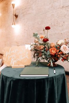 a table with a sign and flowers on it