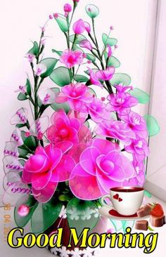 a vase filled with pink flowers sitting on top of a table