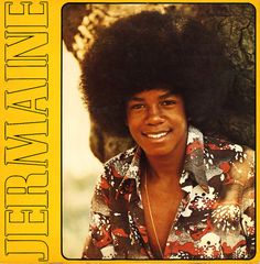 an album cover with the image of a smiling man in floral shirt and afro hair