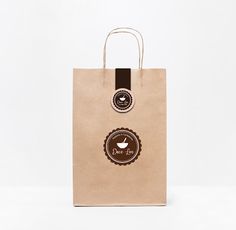 a brown paper bag with two stickers on it