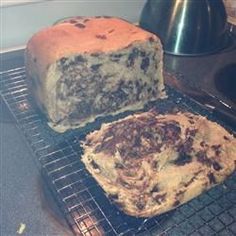 two loaves of bread cooling on a rack