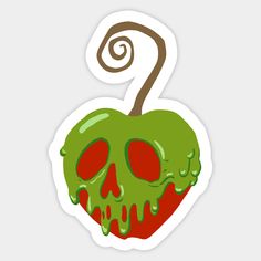 an apple with green and red spooky paint on it's face, sitting next to a spiral sticker