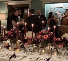 a group of people standing around a dinner table